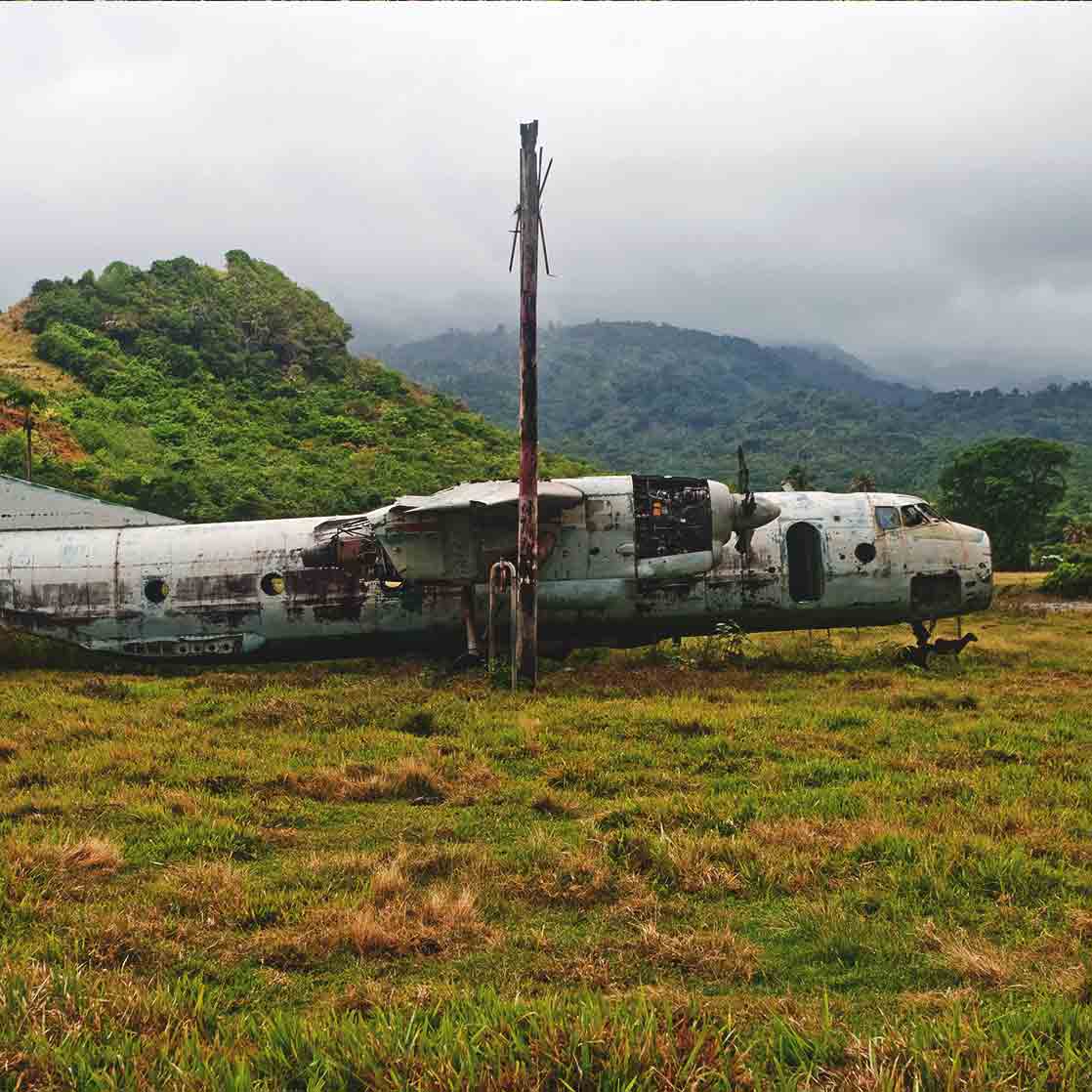 former Soviet plane in field at abandoned air strip in Granada