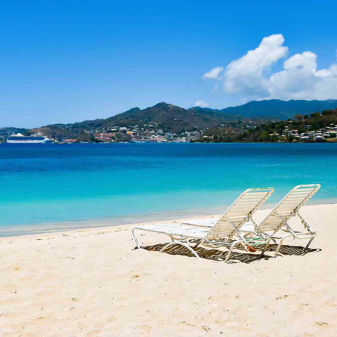 2 beach chairs on a sandy beach in Grenada